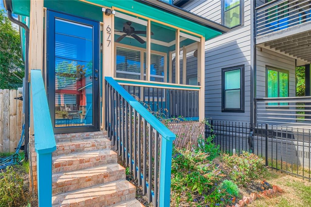 677 Ira Street Southwest Atlanta, GA 30310 - Photo 3 of 28 a view of a house with a small yard and wooden floor and fence