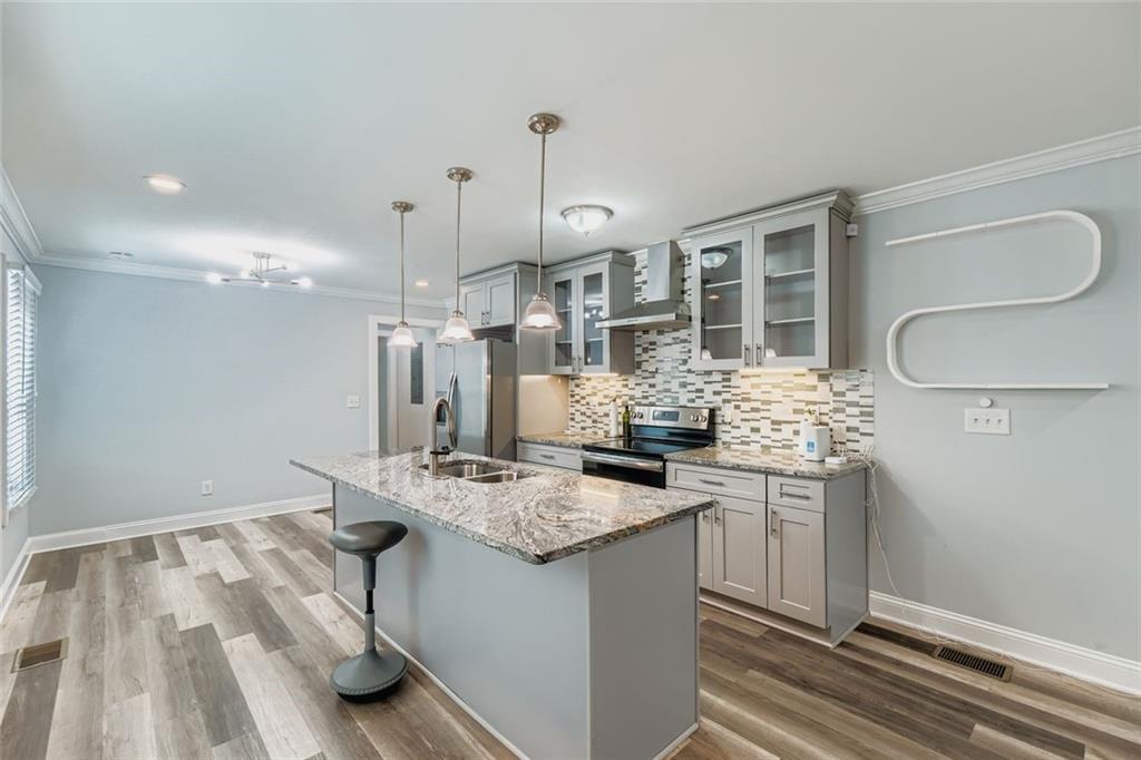 677 Ira Street Southwest Atlanta, GA 30310 - Photo 8 of 28 a kitchen with stainless steel appliances granite countertop a sink stove and refrigerator