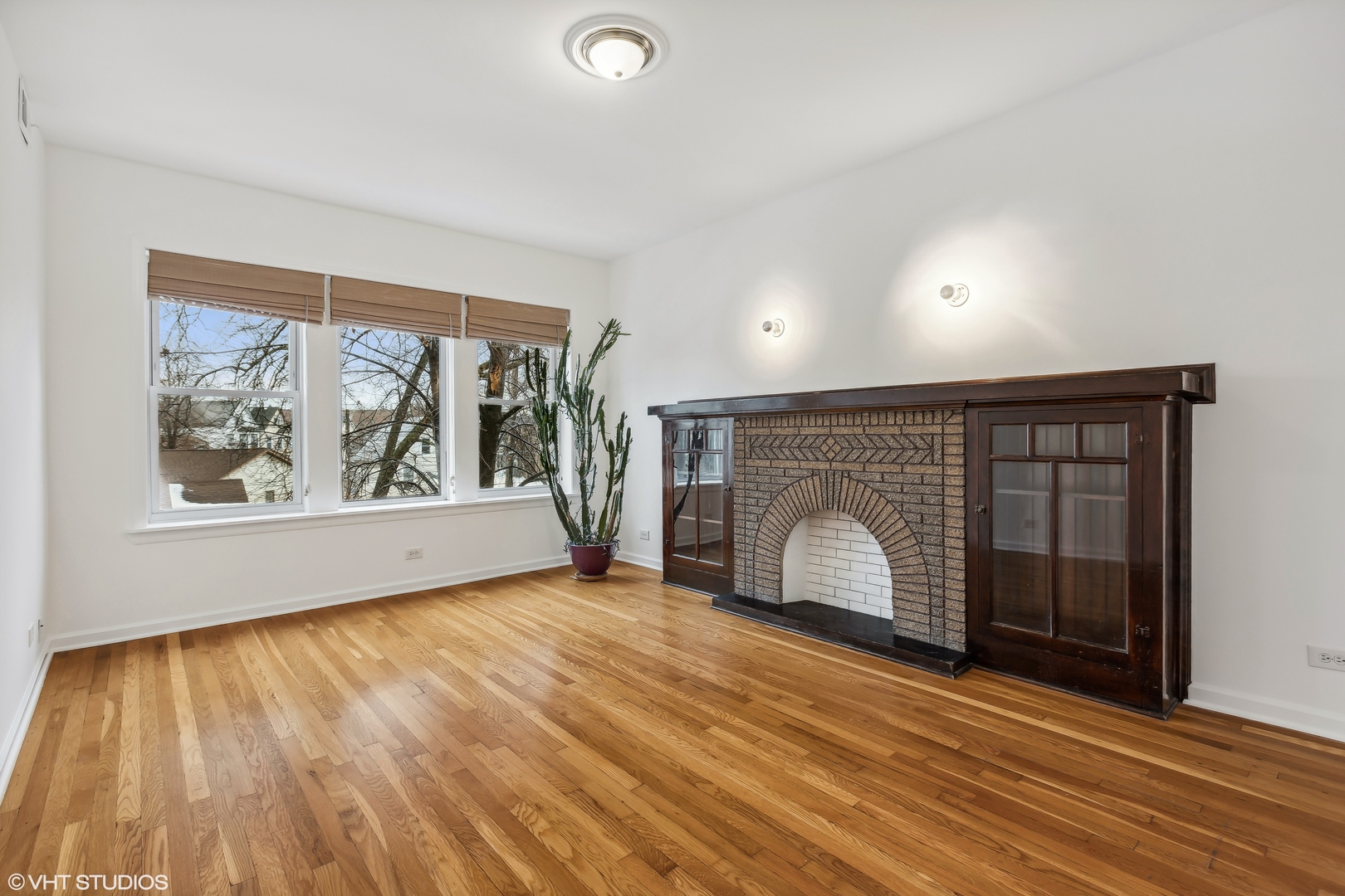 3317 West George Street, Unit 2 Chicago, IL 60618 - Photo 4 of 15 a view of an empty room with wooden floor and a window