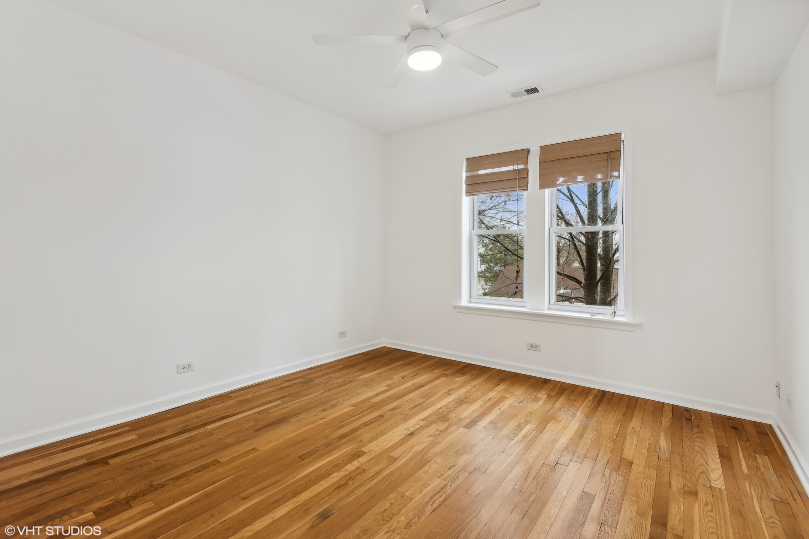 3317 West George Street, Unit 2 Chicago, IL 60618 - Photo 9 of 15 wooden floor in an empty room with a window