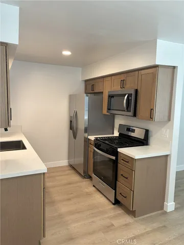 a kitchen with a stove and a refrigerator