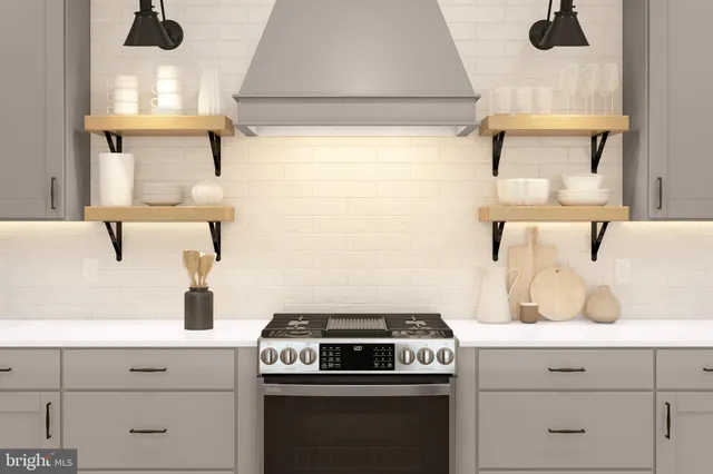 a kitchen with a stove and white cabinets