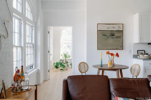 a large bed sitting in a bedroom next to a window