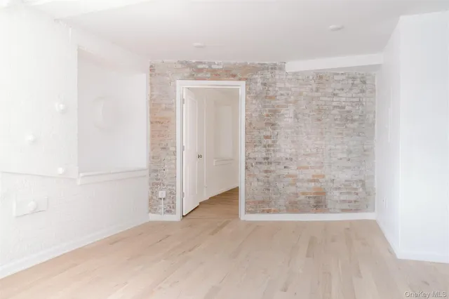an empty room with wooden floor and closet