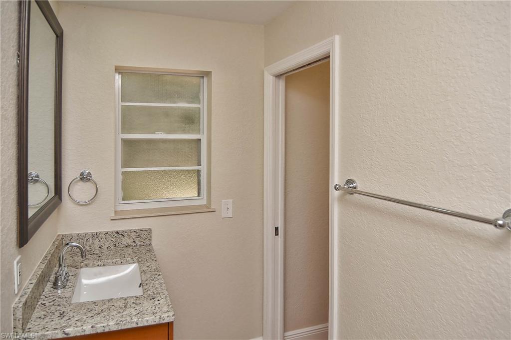 19070 Evergreen Road Fort Myers, FL 33967 - Photo 11 of 25 a bathroom with a sink a mirror and shower