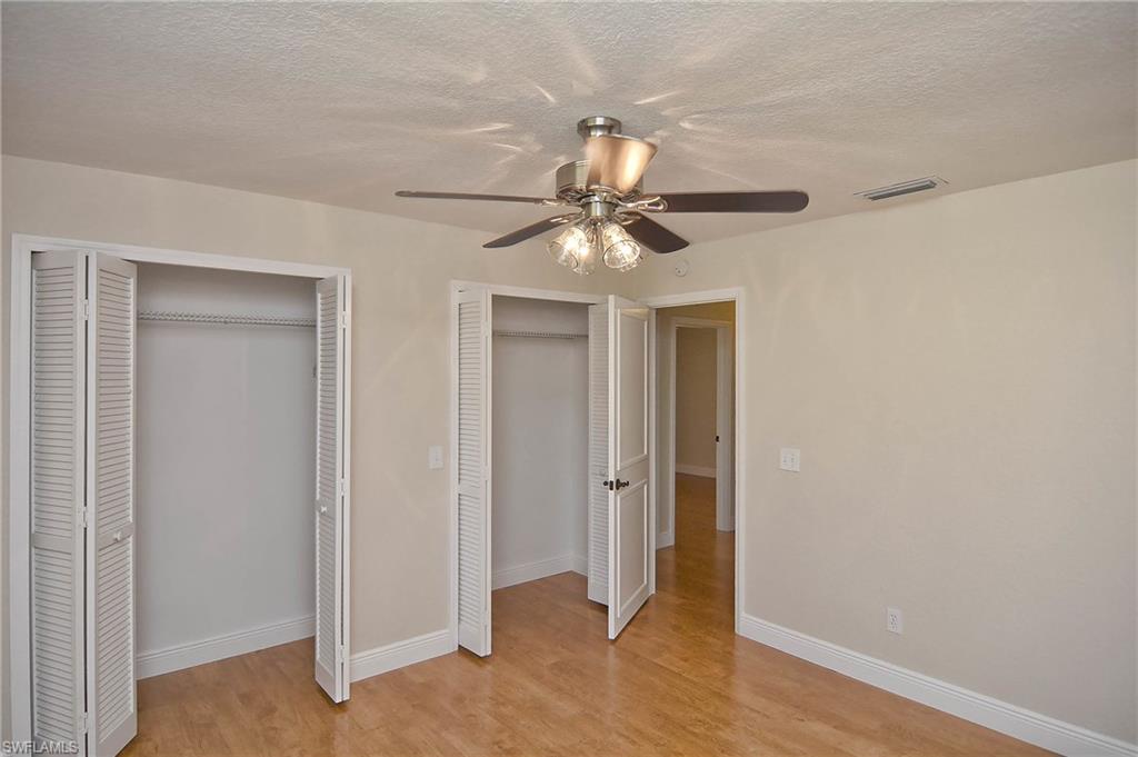 19070 Evergreen Road Fort Myers, FL 33967 - Photo 12 of 25 a view of a livingroom with a ceiling fan and wooden floor