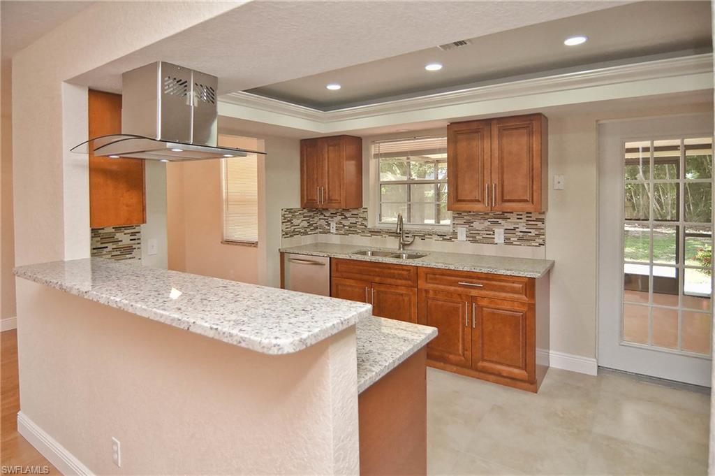 19070 Evergreen Road Fort Myers, FL 33967 - Photo 13 of 25 a kitchen with stainless steel appliances granite countertop a sink stove and refrigerator