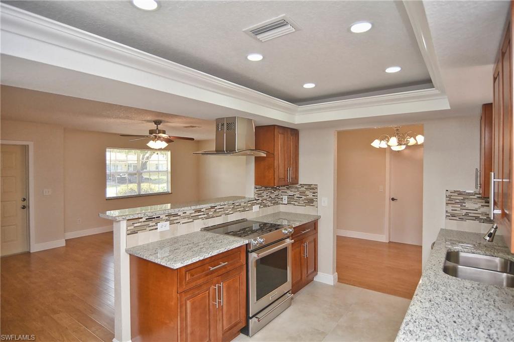 19070 Evergreen Road Fort Myers, FL 33967 - Photo 15 of 25 a kitchen with a stove a sink and a refrigerator