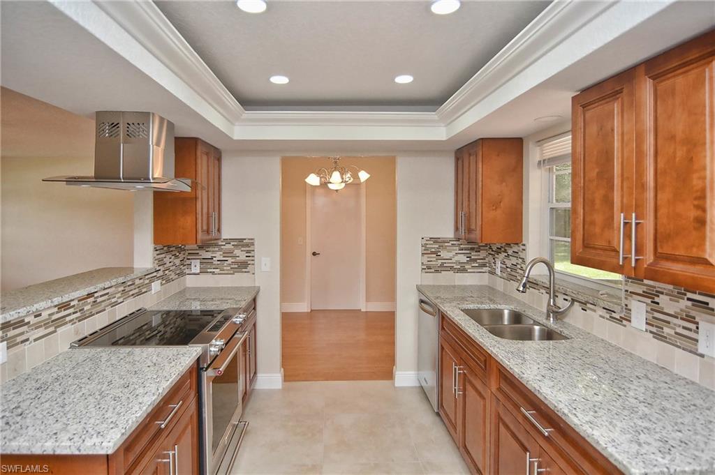 19070 Evergreen Road Fort Myers, FL 33967 - Photo 16 of 25 a kitchen with a sink stove and cabinets
