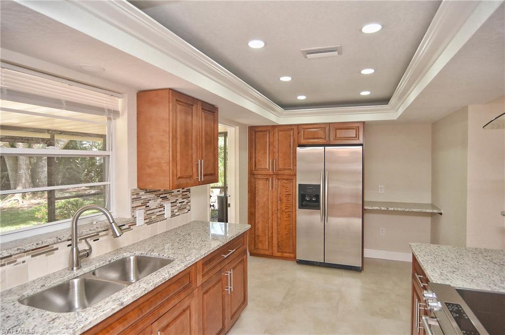 19070 Evergreen Road Fort Myers, FL 33967 - Photo 17 of 25 a kitchen with stainless steel appliances granite countertop a sink and a refrigerator