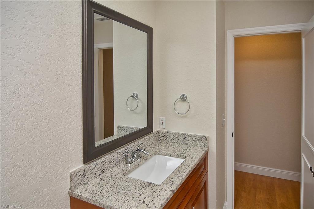 19070 Evergreen Road Fort Myers, FL 33967 - Photo 6 of 25 a bathroom with a granite countertop sink and a mirror