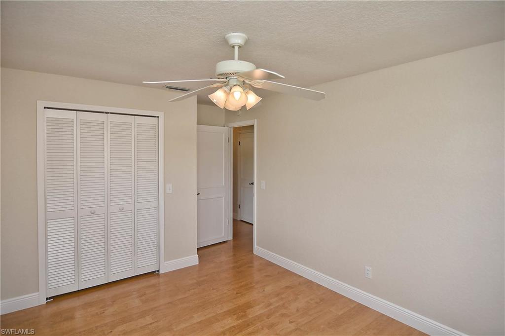 19070 Evergreen Road Fort Myers, FL 33967 - Photo 8 of 25 a view of a chandelier fan and hardwood floor