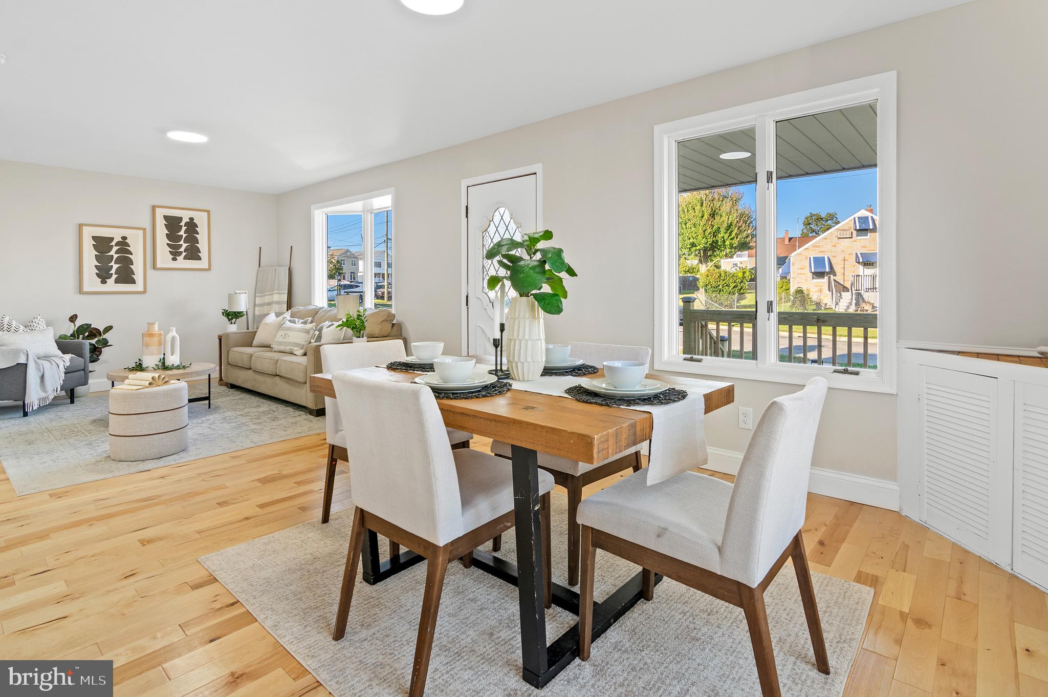 a dining room with furniture a rug and wooden floor