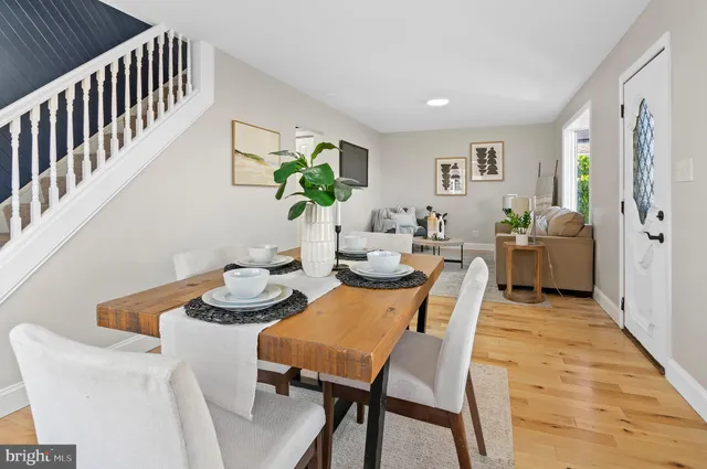a dining room with furniture a rug and wooden floor