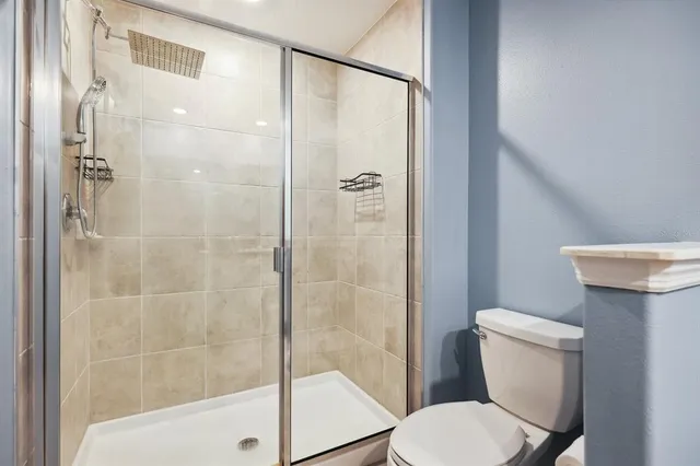 a white toilet sitting next to a bathroom