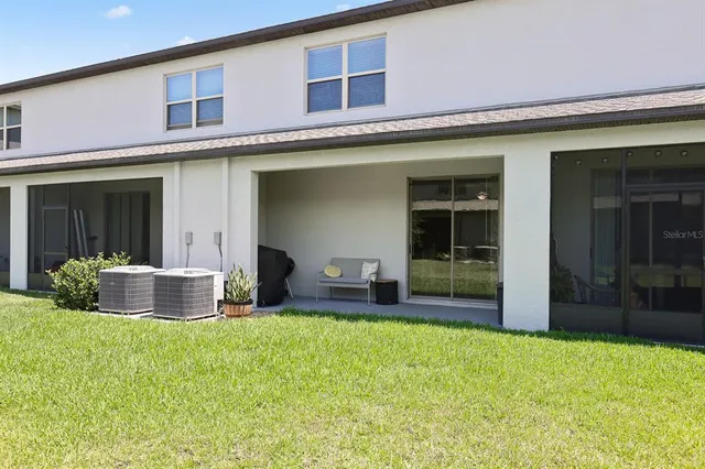front view of a brick house with a yard