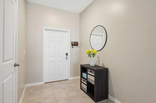 a picture of a room with a mirror and a wooden door