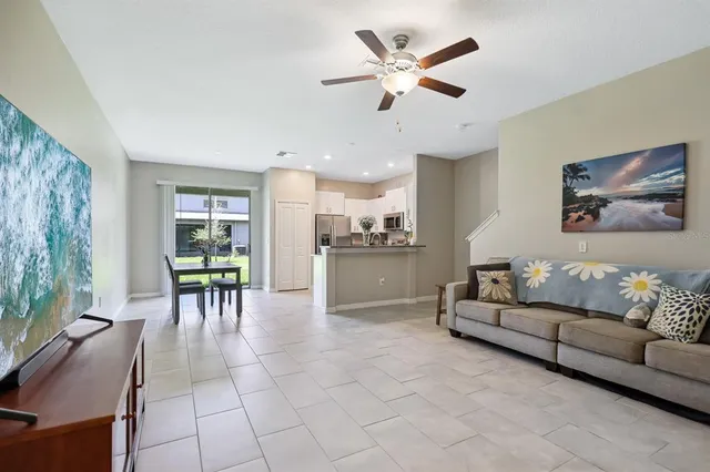 a living room with furniture and kitchen view
