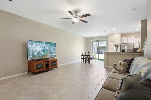 a living room with furniture and kitchen view