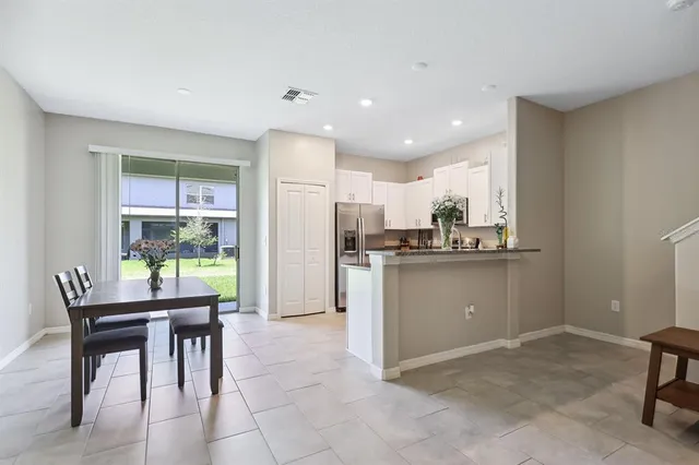a kitchen with a refrigerator and a table