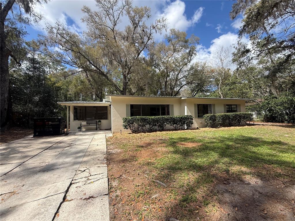 620 Northwest 36th Drive Gainesville, FL 32607 - Photo 1 of 1 a front view of a house with a yard and a garage