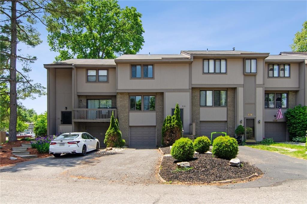a car parked in front of a brick house