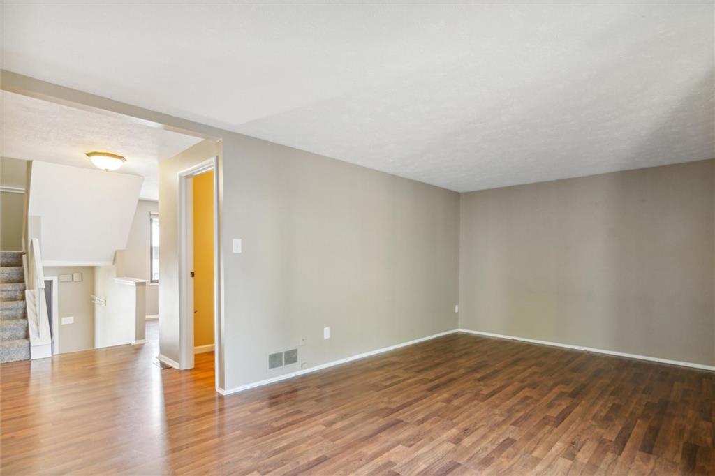 310 Ridge Point Circle Bridgeville, PA 15017 - Photo 12 of 24 a view of empty room with wooden floor and windows
