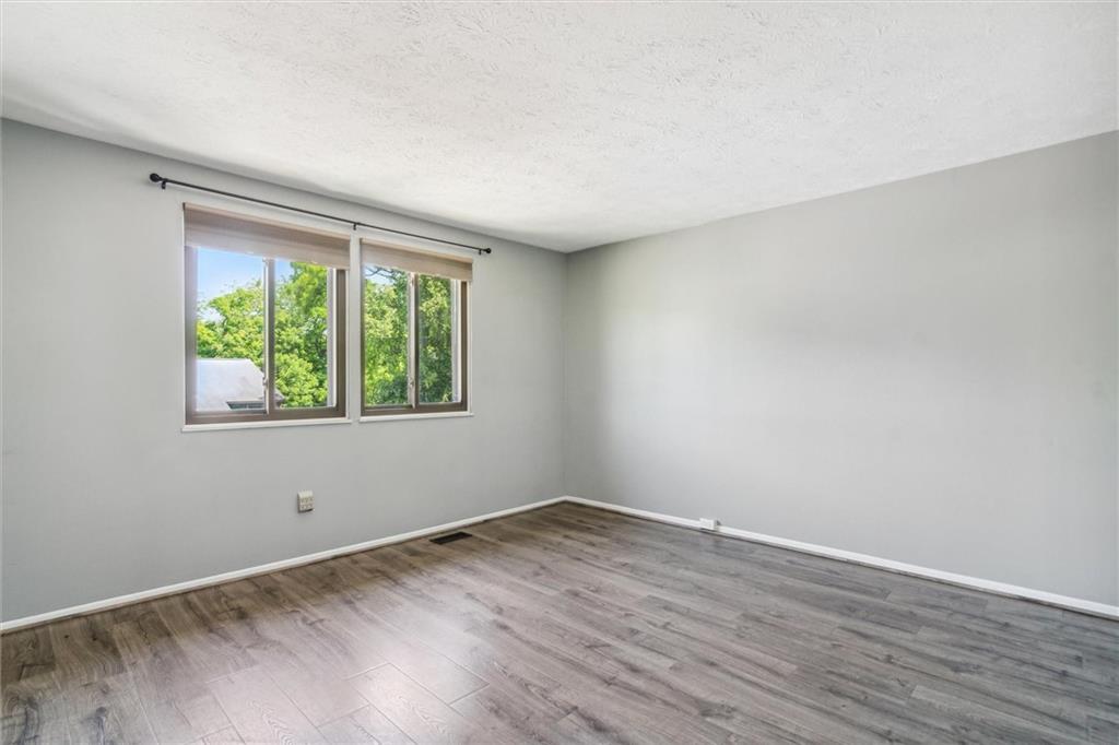 310 Ridge Point Circle Bridgeville, PA 15017 - Photo 16 of 24 a view of an empty room with wooden floor and a window