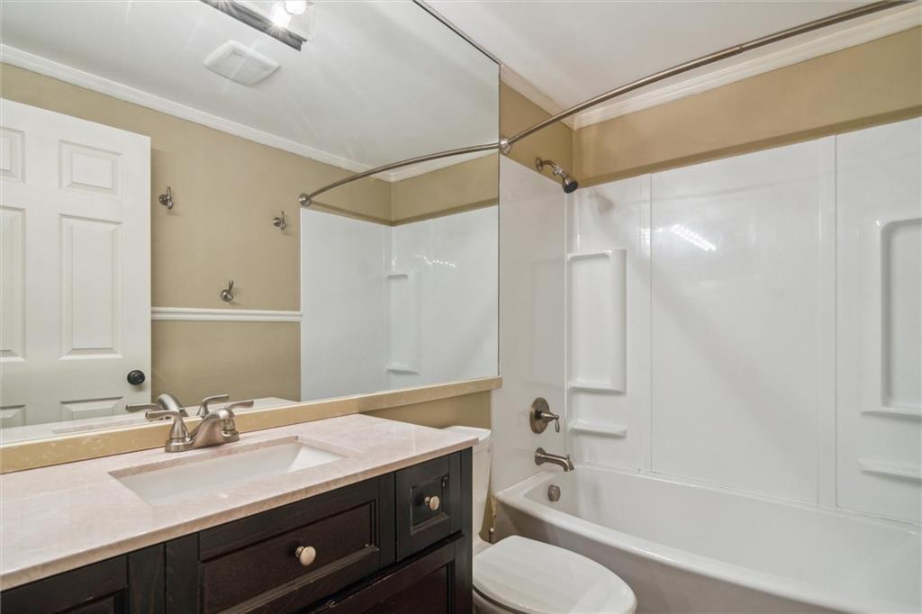 310 Ridge Point Circle Bridgeville, PA 15017 - Photo 18 of 24 a bathroom with a granite countertop sink toilet a shower and a mirror
