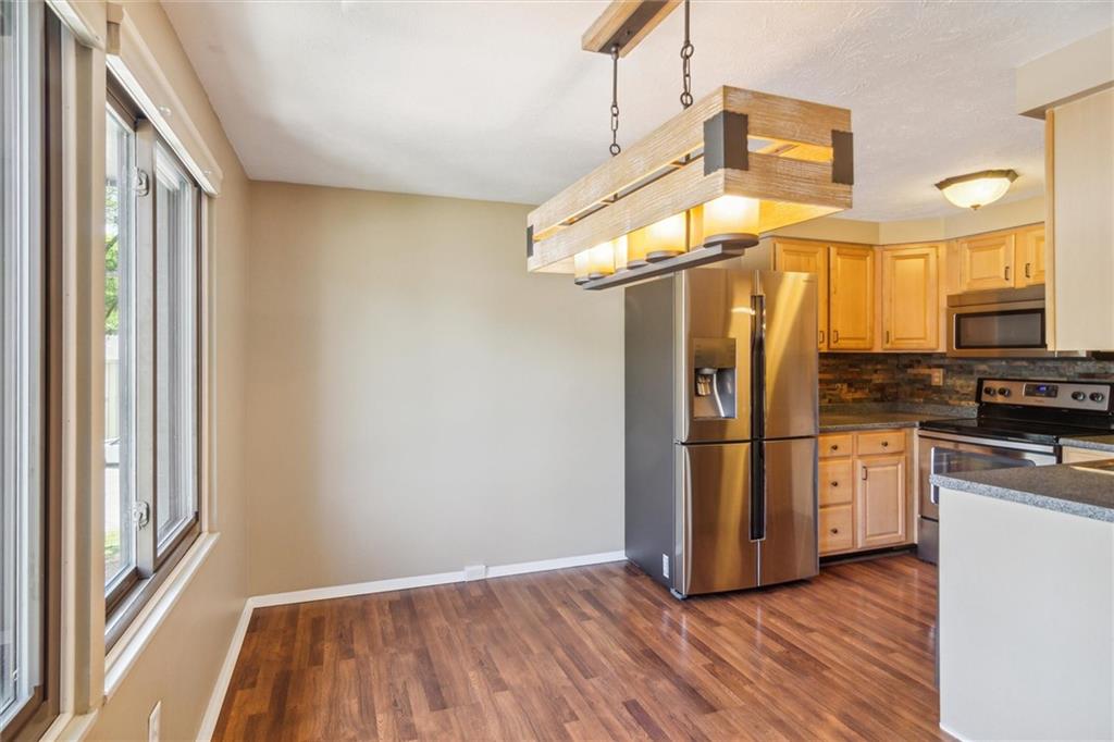 310 Ridge Point Circle Bridgeville, PA 15017 - Photo 6 of 24 a kitchen with a refrigerator a stove top oven a sink and a window