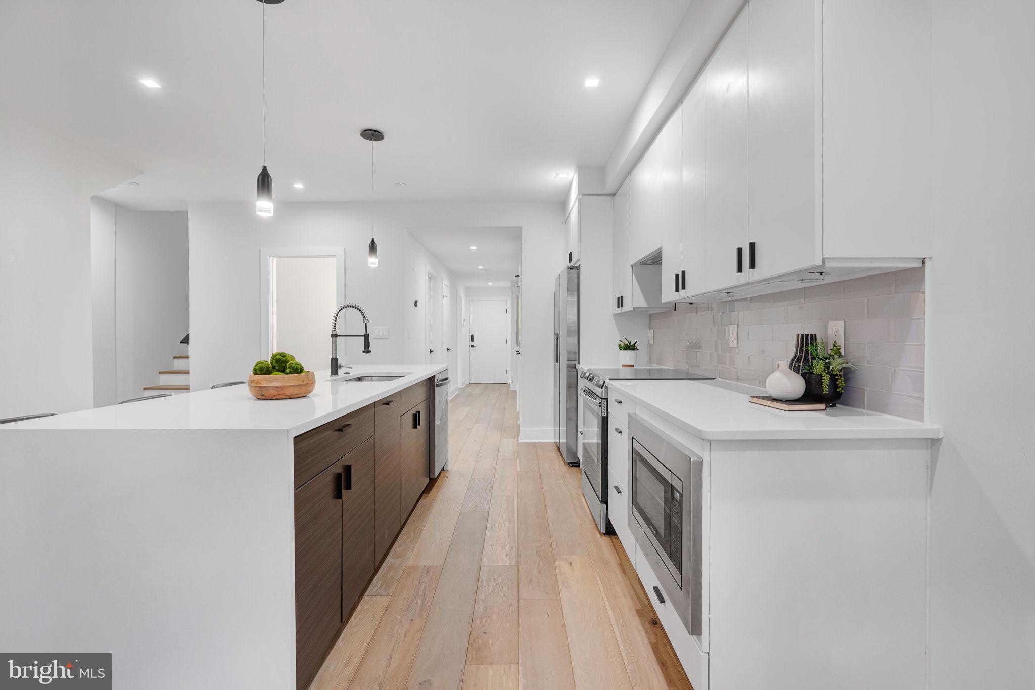 320 Webster Street Northwest, Unit 2 Washington, DC 20011 - Photo 6 of 25 a large white kitchen with lots of counter space and a sink