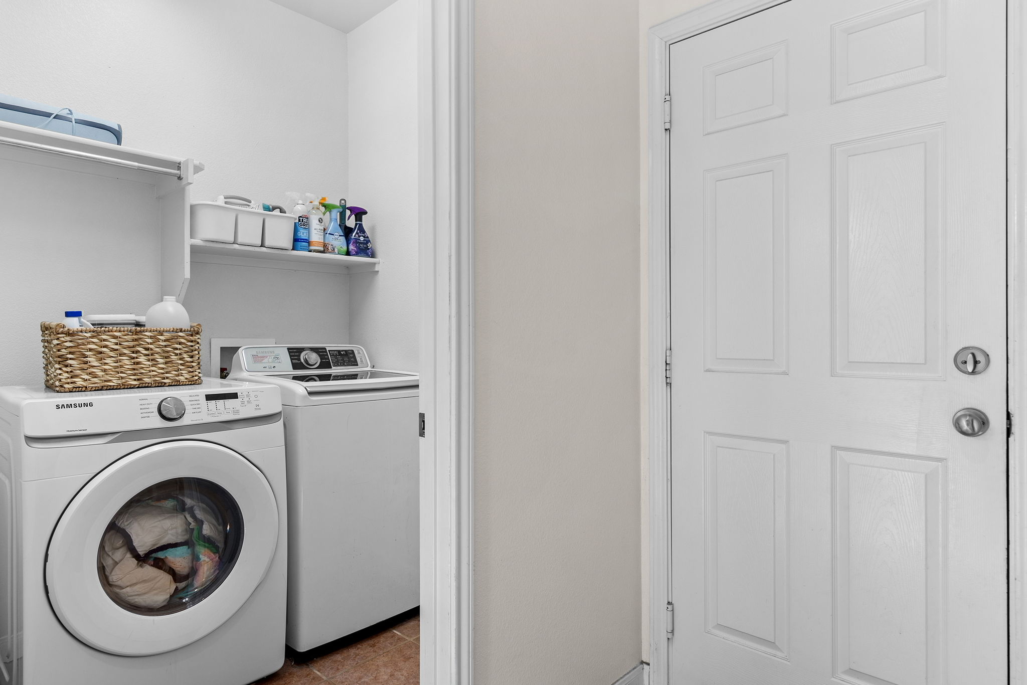 3517 Shiraz Loop Round Rock, TX 78665 - Photo 34 of 40 Dedicated laundry area featuring a front-loading washing machine, a top-loading washing machine, and upper storage shelving