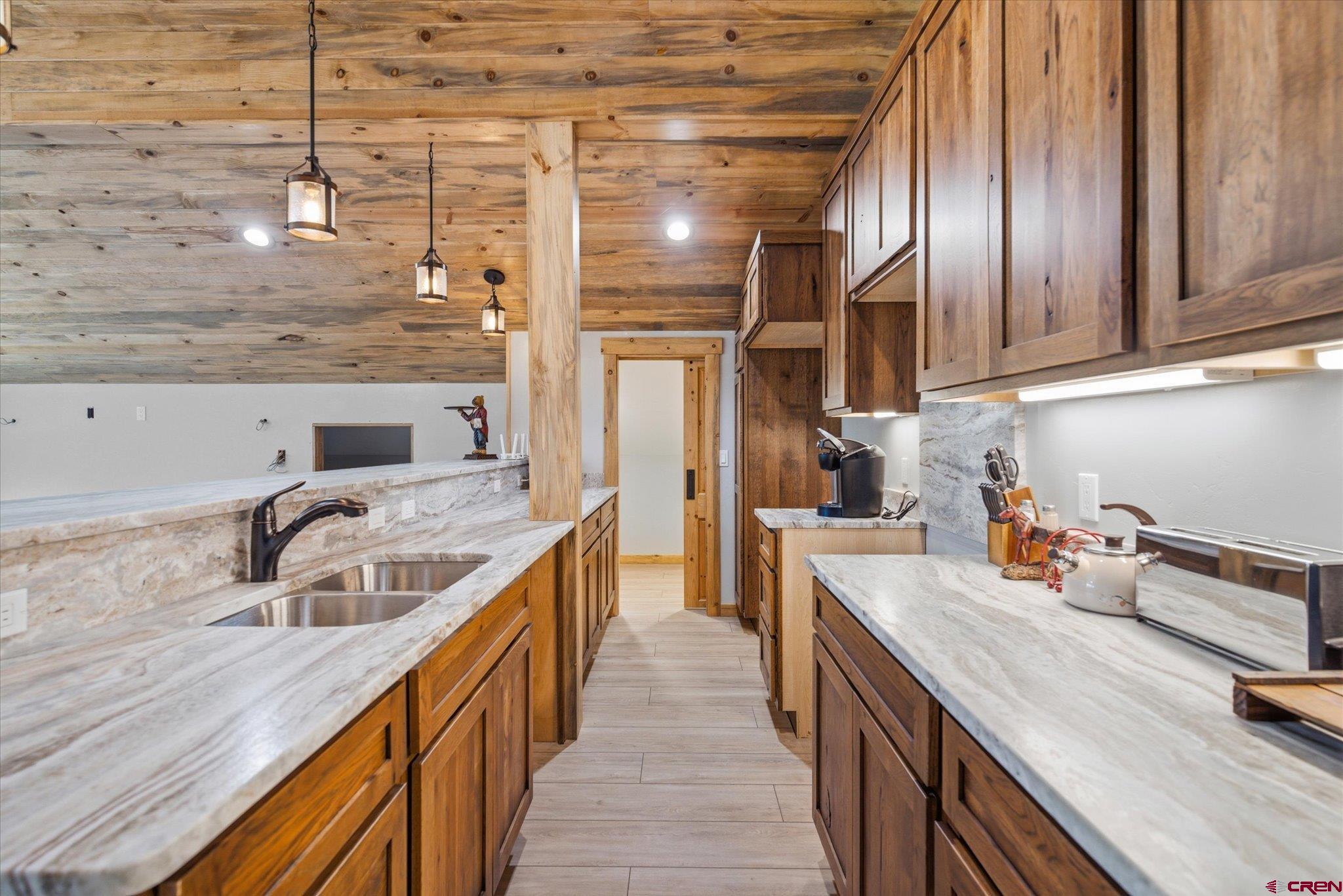 197 Hummingbird Way Bayfield, CO 81122 - Photo 34 of 44 a kitchen with granite countertop lots of counter top space and wooden floor