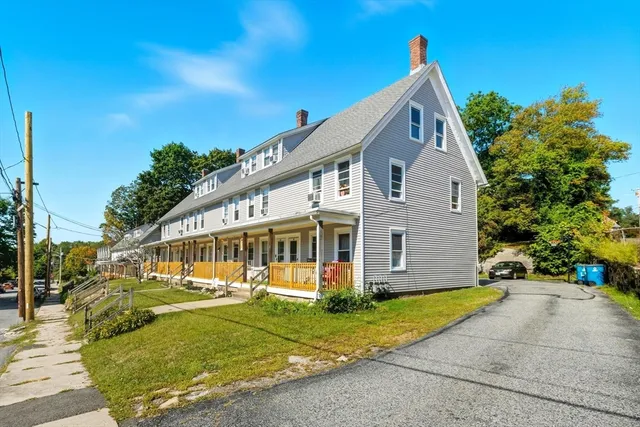 a view of a house with garden and trees