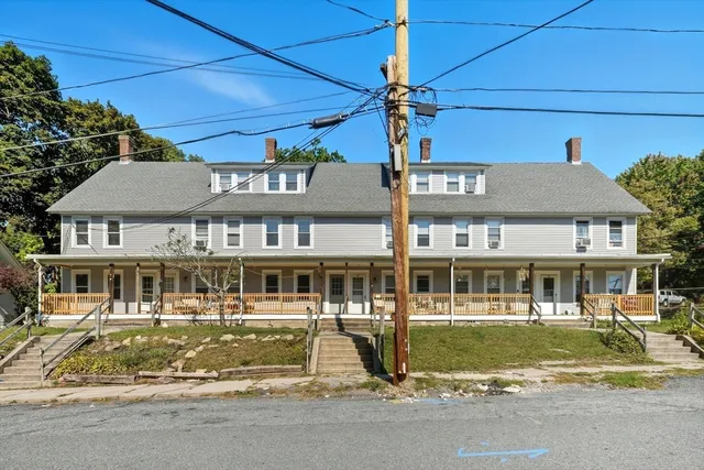 a front view of a residential apartment building with a yard