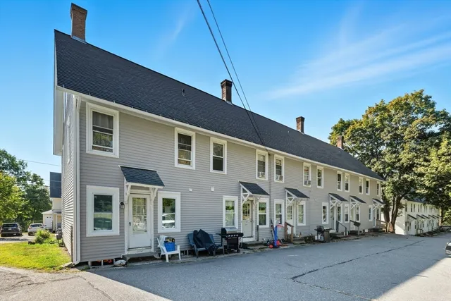 a couple of cars parked in front of a house