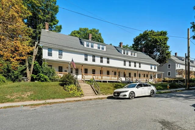 a car parked in front of a white house
