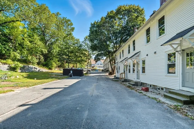 a view of a street with houses on both side