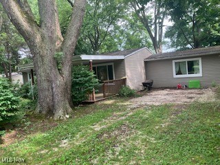 3065 Polly Road Ravenna, OH 44266 - Photo 2 of 11 View of front of property with a wooden deck and a front yard