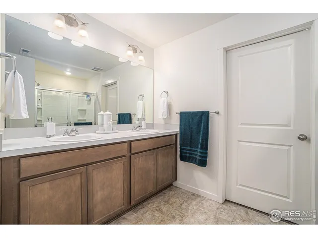 a bathroom with a double vanity sink and mirror
