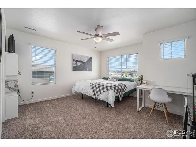 a bedroom with a bed a table and chair