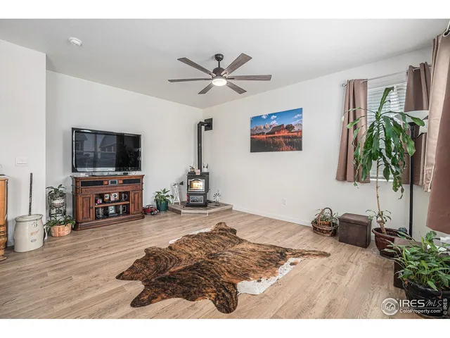 a living room with furniture and a flat screen tv with wooden floor