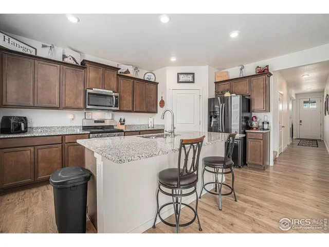 a kitchen with kitchen island a refrigerator stove and microwave