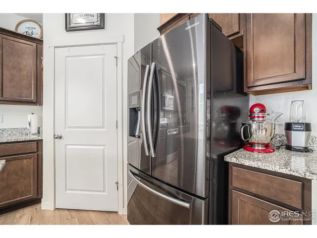 a kitchen with stainless steel appliances granite countertop a refrigerator and a stove