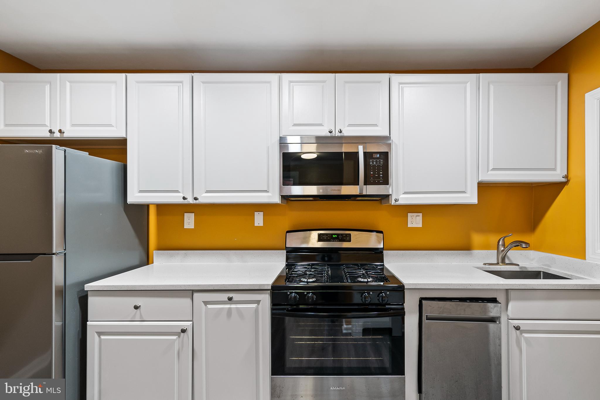 2412 18th Street Southeast Washington, DC 20020 - Photo 12 of 33 a kitchen with appliances a sink and cabinets