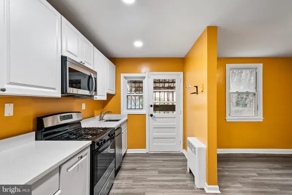 a kitchen with stainless steel appliances granite countertop a stove and a refrigerator