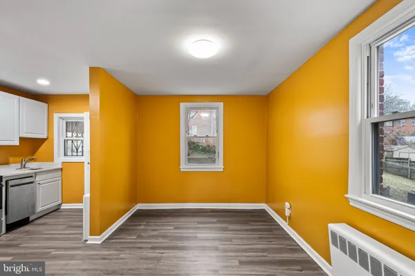 a view of a room with wooden floor and a window
