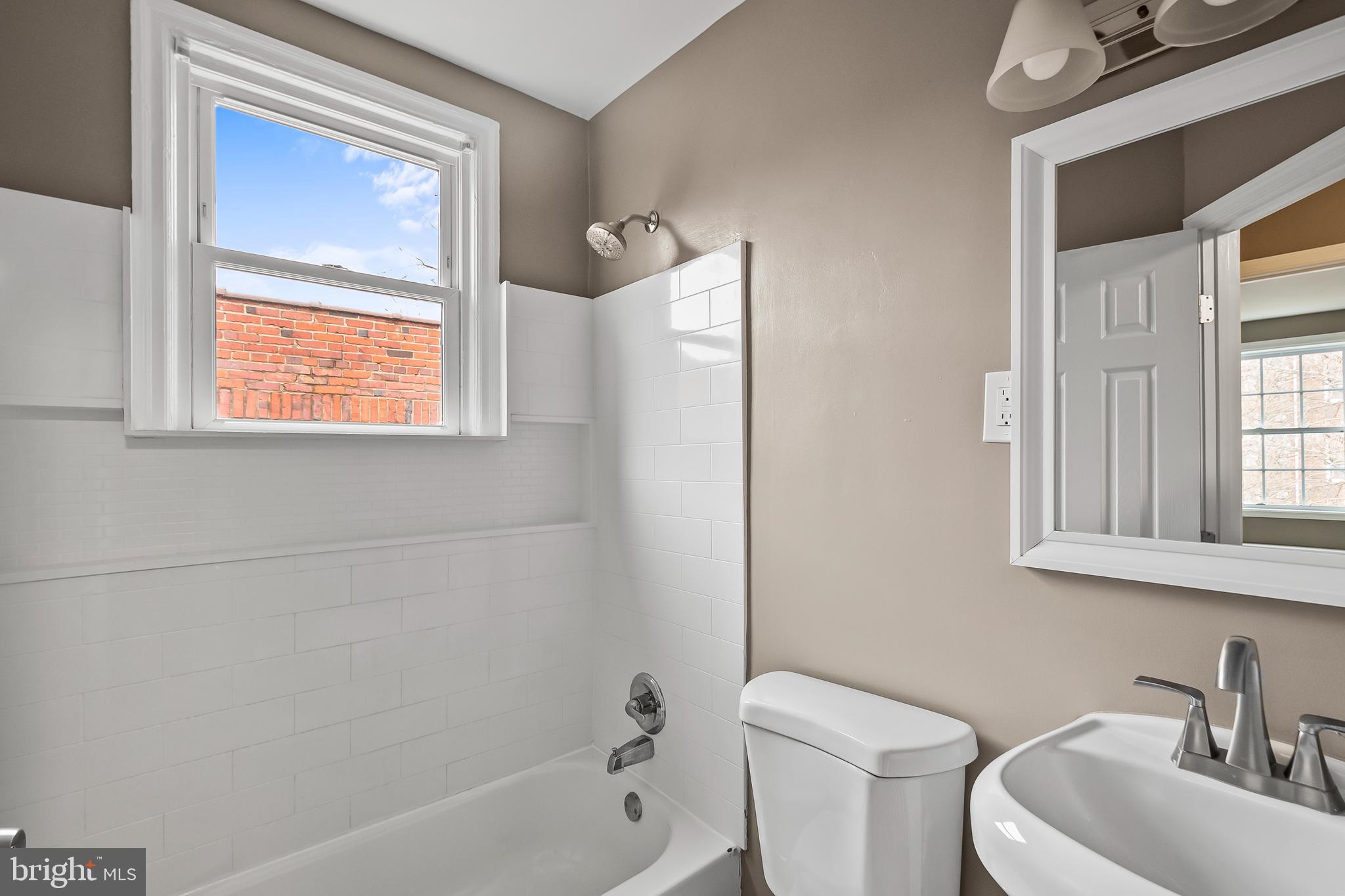 2412 18th Street Southeast Washington, DC 20020 - Photo 19 of 33 a bath room with a toilet a sink and a bath tub