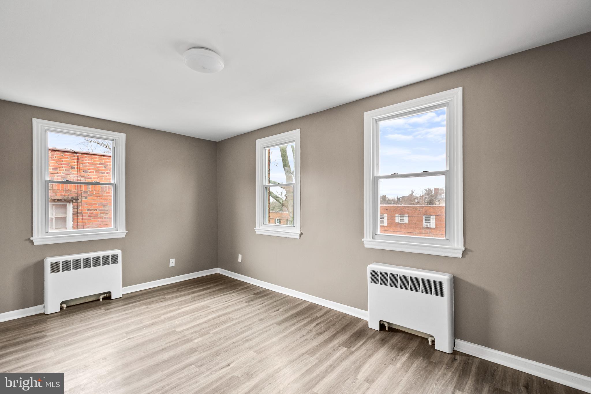 2412 18th Street Southeast Washington, DC 20020 - Photo 22 of 33 a view of an empty room with a window and wooden floor