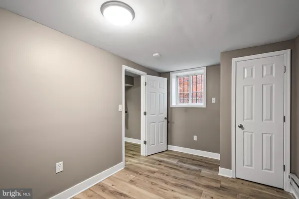 an empty room with closet and wooden floor